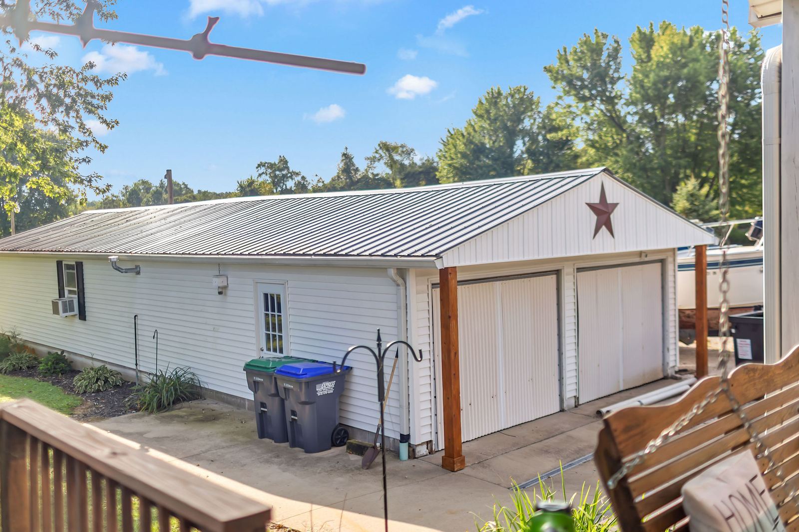 Detached garage with two bay doors seen from the back deck